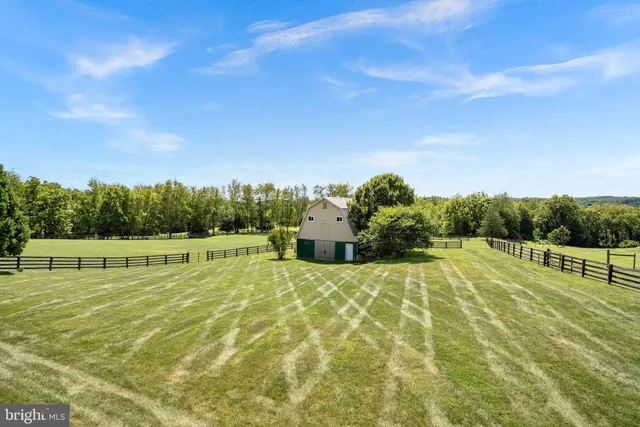 a view of a swimming pool with an outdoor seating and a yard
