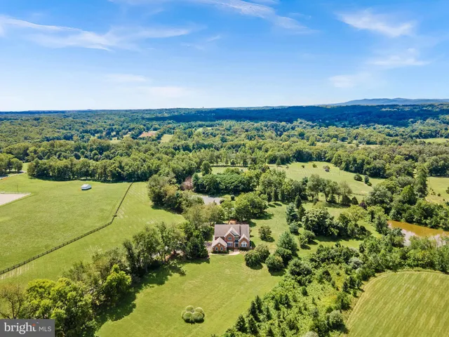 an aerial view of a houses with a yard
