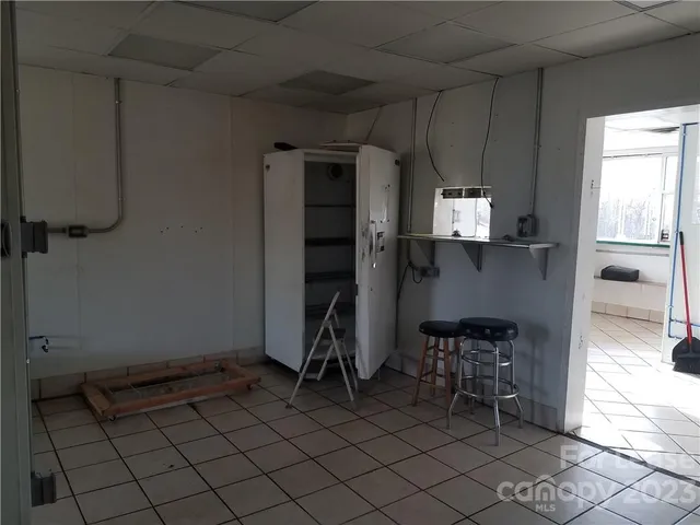 a view of a backyard with large trees