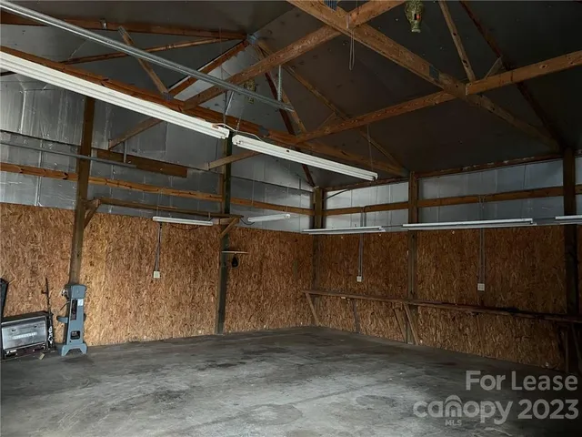 a view of a yard with wooden fence