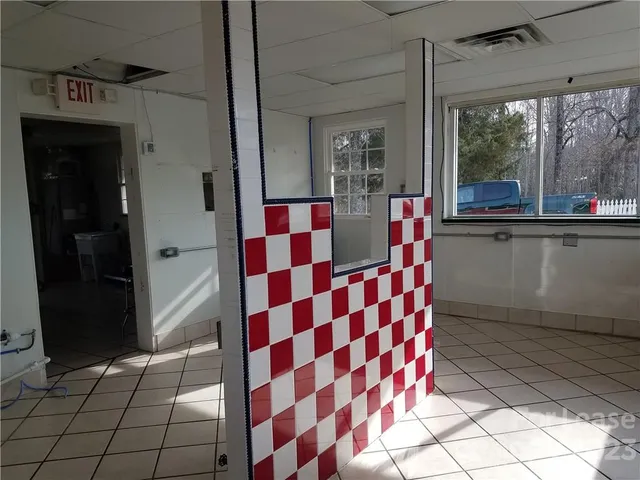 a view of a street next to a fence