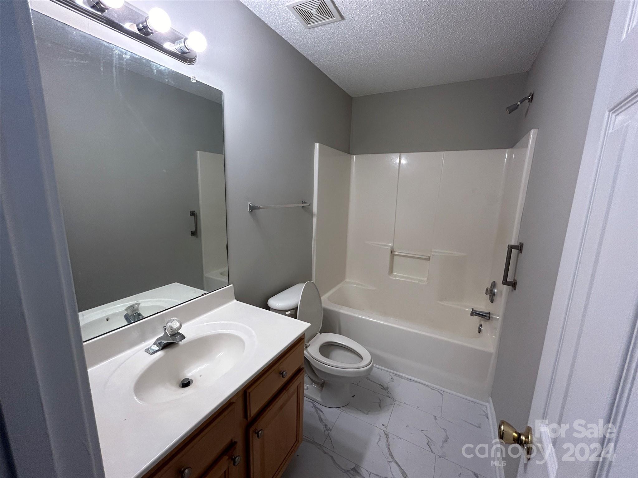 10511 Prairie Ridge Lane Charlotte, NC 28213 - Photo 11 of 17 a bathroom with a sink a toilet a tub and shower
