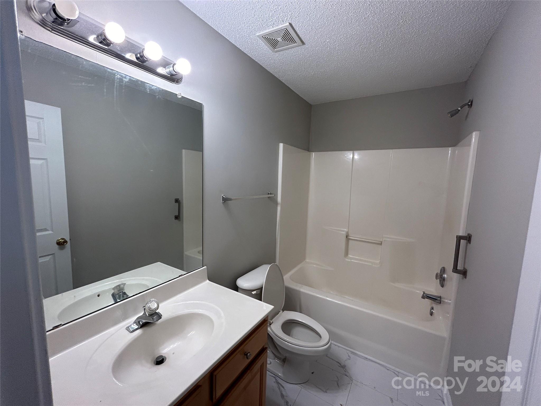 10511 Prairie Ridge Lane Charlotte, NC 28213 - Photo 13 of 17 a bathroom with a sink a toilet and shower