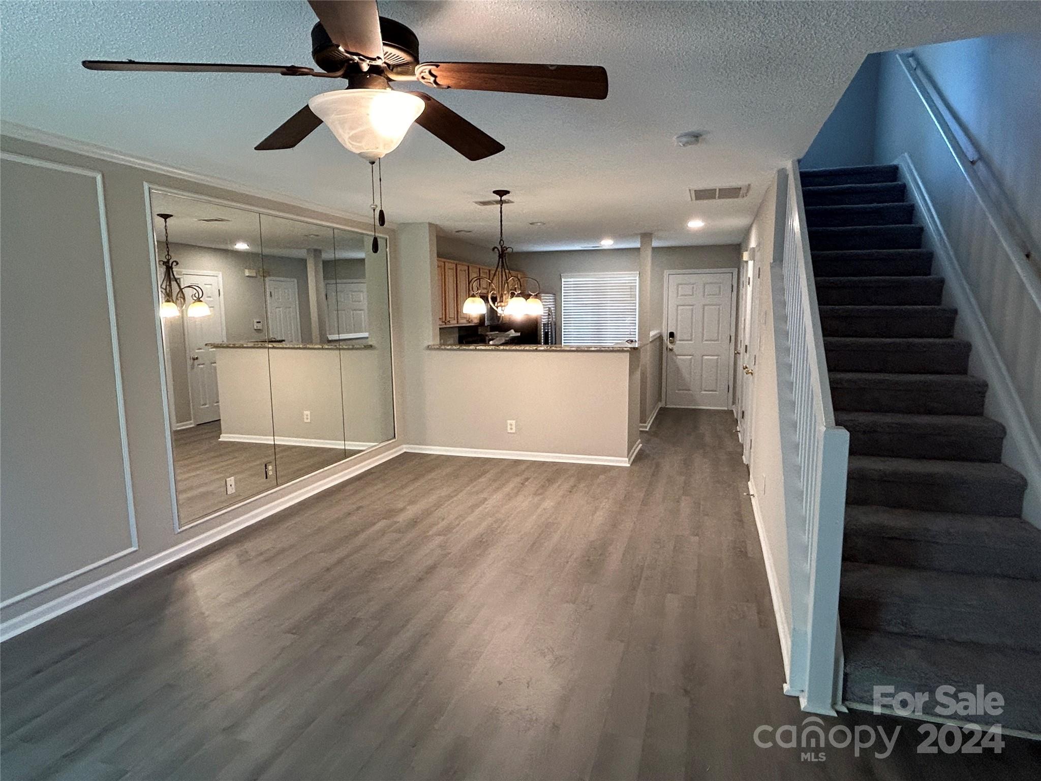 10511 Prairie Ridge Lane Charlotte, NC 28213 - Photo 7 of 17 a view of a hallway view with wooden floor and a ceiling fan