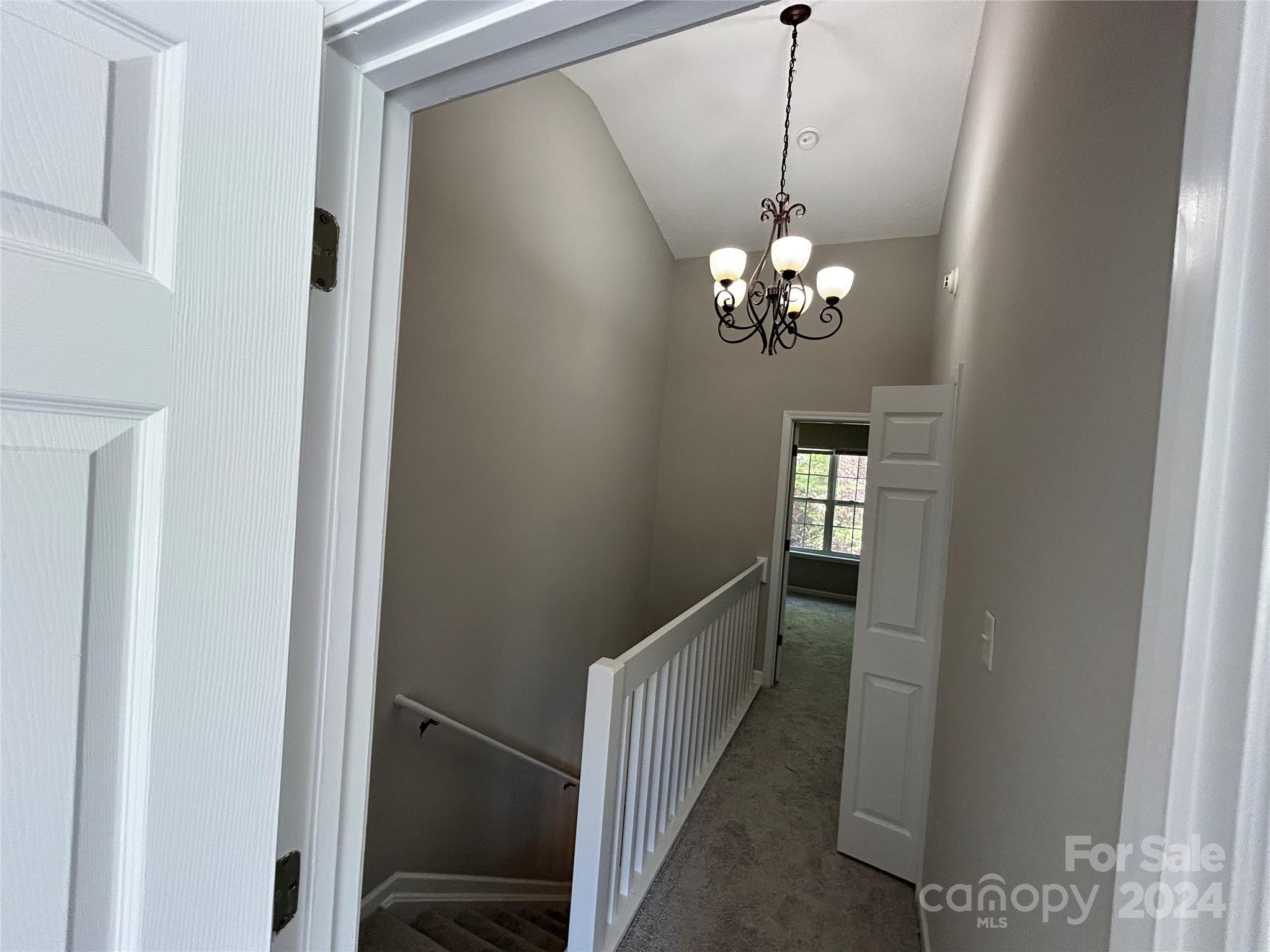 10511 Prairie Ridge Lane Charlotte, NC 28213 - Photo 9 of 17 a view of a hallway with a chandelier