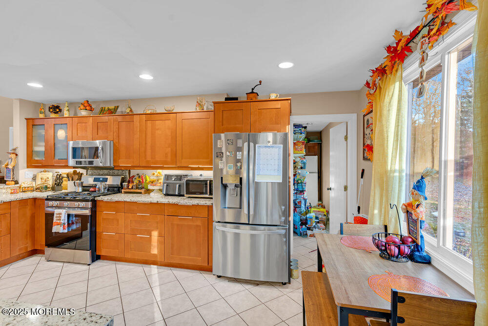 254 Alexander Avenue Howell, NJ 07731 - Photo 17 of 24 a kitchen with stainless steel appliances granite countertop a refrigerator and a stove