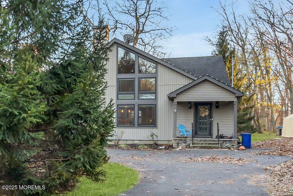 254 Alexander Avenue Howell, NJ 07731 - Photo 2 of 24 a front view of a house with a garden and trees