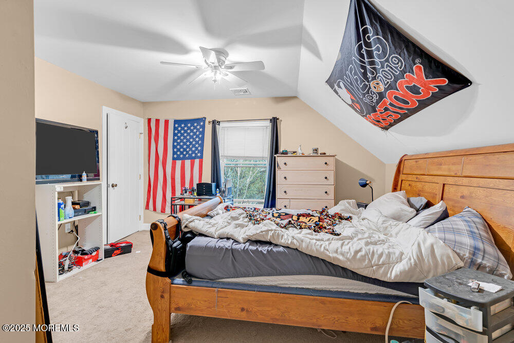 254 Alexander Avenue Howell, NJ 07731 - Photo 21 of 24 a bedroom with a bed and a flat screen tv