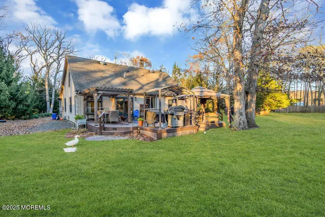 a view of a yard with table and chairs and a large tree