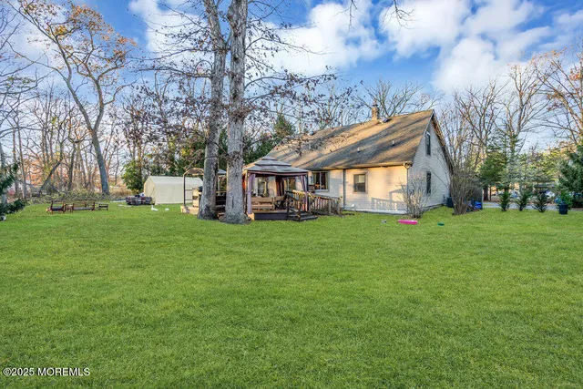 a view of house with backyard