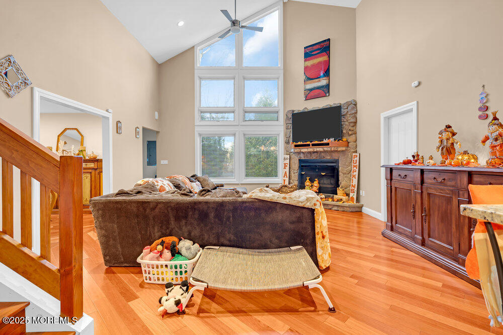 254 Alexander Avenue Howell, NJ 07731 - Photo 7 of 24 a living room with furniture a flat screen tv and a fireplace