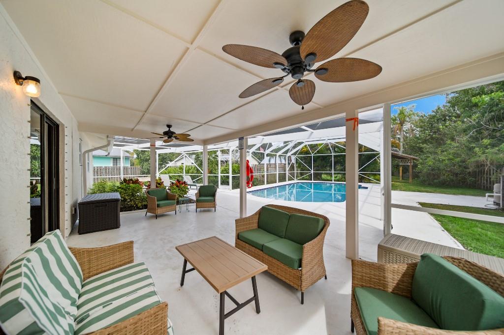 6275 Southeast Thomas Drive Stuart, FL 34997 - Photo 1 of 27 a outdoor space with patio the couches and a dining table with garden view