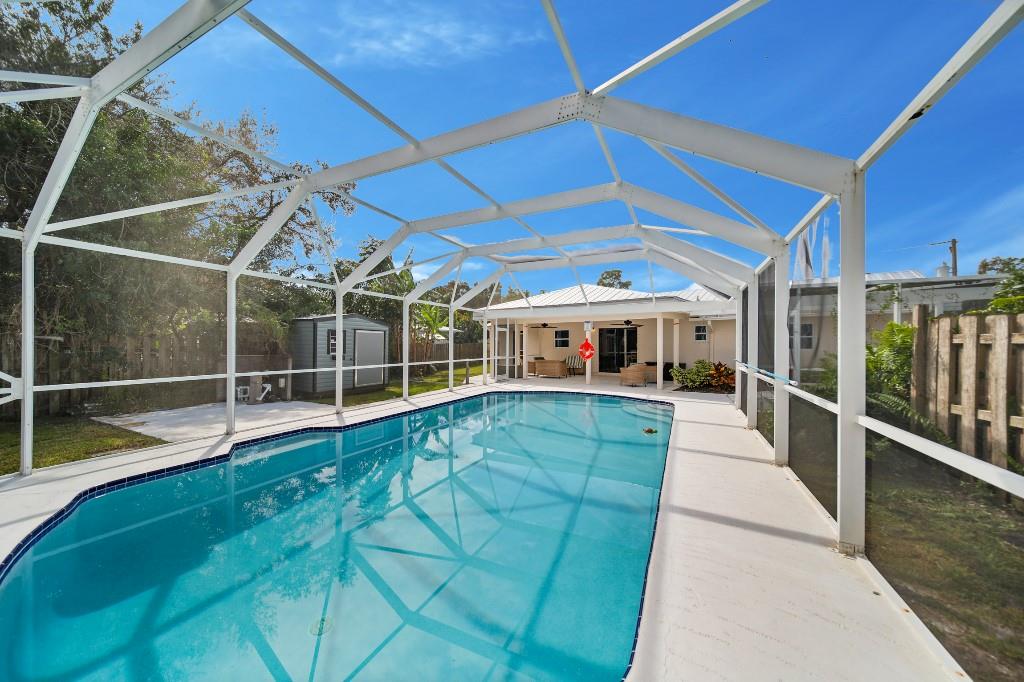 6275 Southeast Thomas Drive Stuart, FL 34997 - Photo 23 of 27 a view of a swimming pool with a porch