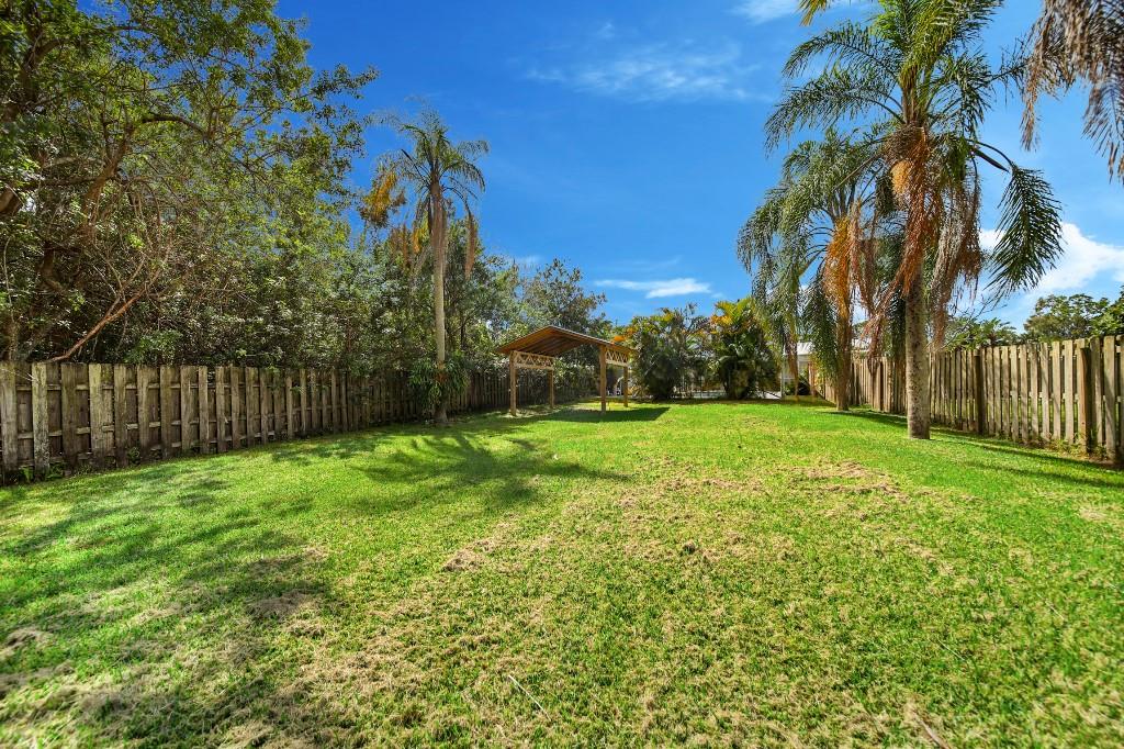6275 Southeast Thomas Drive Stuart, FL 34997 - Photo 25 of 27 a view of a yard with a tree