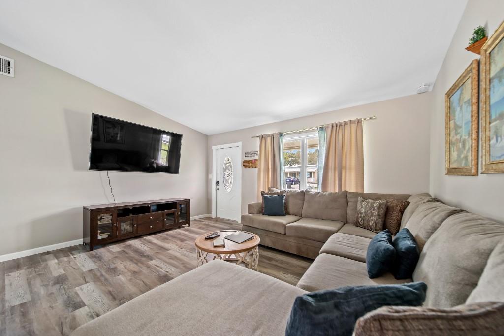 6275 Southeast Thomas Drive Stuart, FL 34997 - Photo 7 of 27 a living room with furniture and a flat screen tv