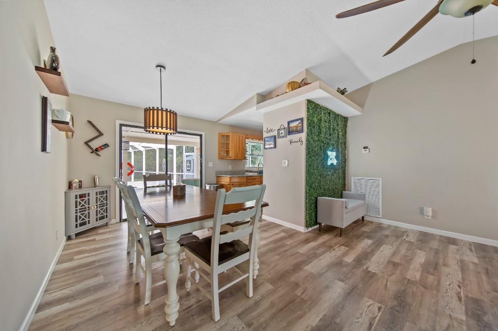 6275 Southeast Thomas Drive Stuart, FL 34997 - Photo 8 of 27 a view of a dining room with furniture window and wooden floor