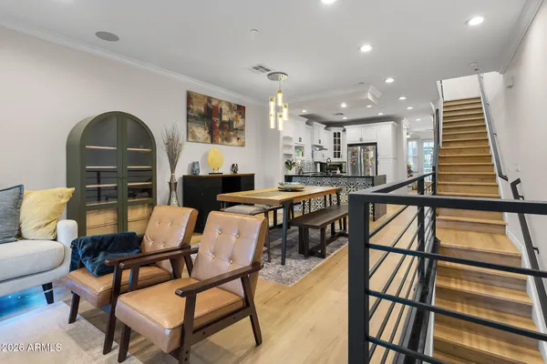a kitchen with kitchen island granite countertop a refrigerator oven a sink and cabinets