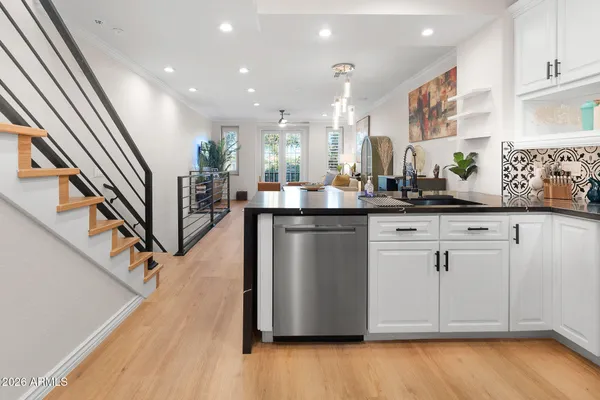 a view of kitchen with stainless steel appliances and refrigerator