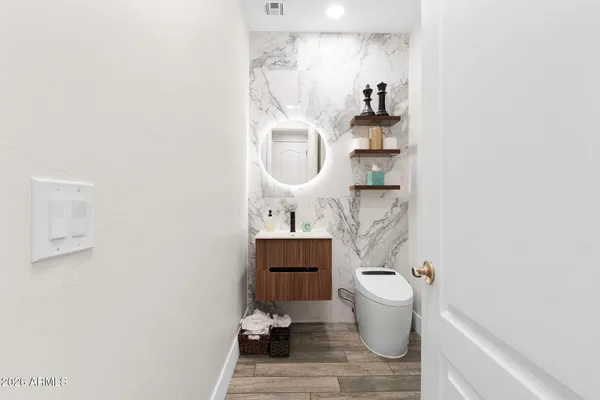 a living room with furniture a flat screen tv and a window