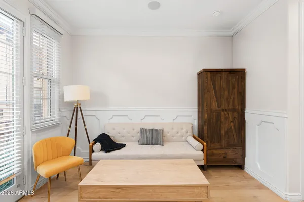 a bed sitting in a bedroom next to a window