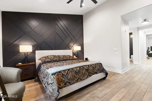 a bathroom with a granite countertop sink a mirror and shower