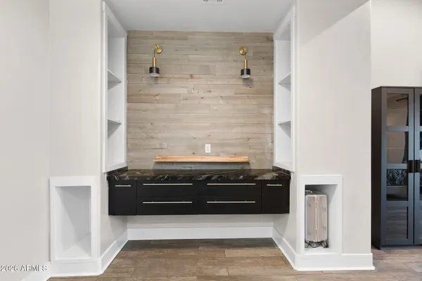a bathroom with a granite countertop sink a mirror and a shower