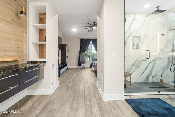 a view of walk in closet with clothes and shoes