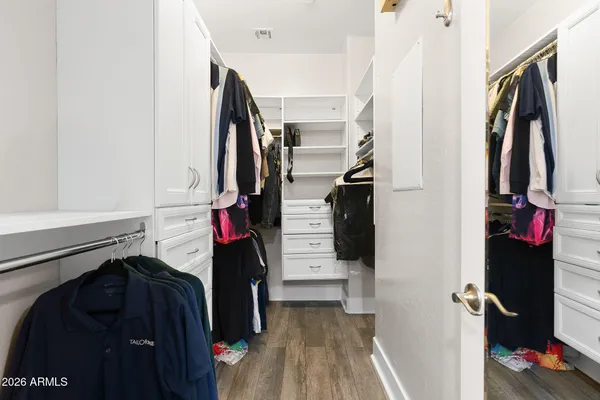 a bedroom with a bed and flat screen tv