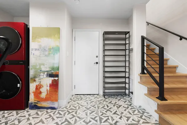 a view of a hallway with washer and dryer