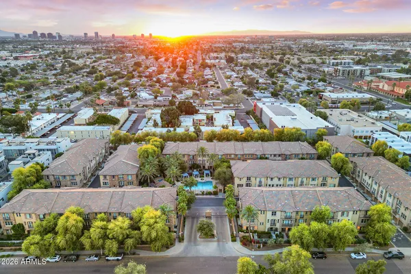 an aerial view of multiple houses with a yard