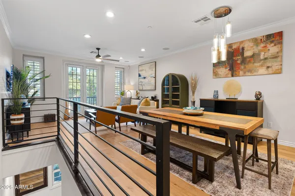 a living room with furniture a flat screen tv and a large window