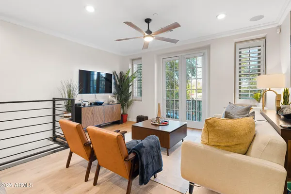 a living room with furniture and a wooden floor