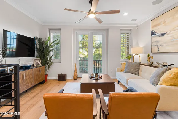 a living room with furniture a rug and a table