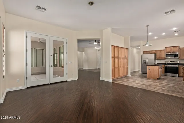 a view of a kitchen with wooden floor and a sink
