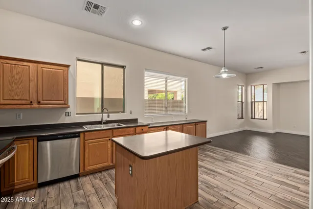 a kitchen with sink cabinets and wooden floor