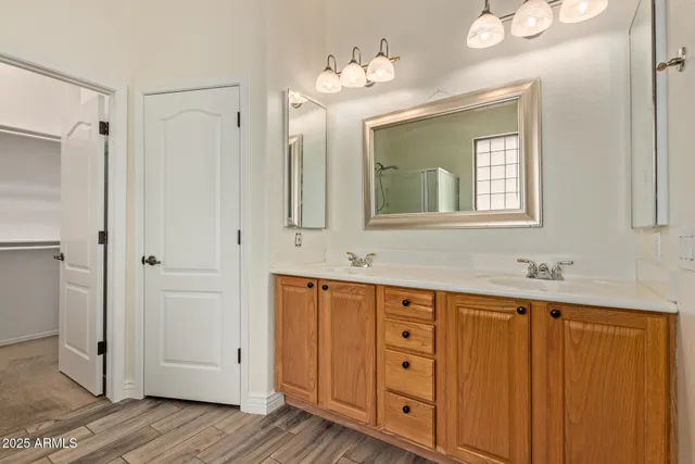 a bathroom with a double vanity sink and mirror