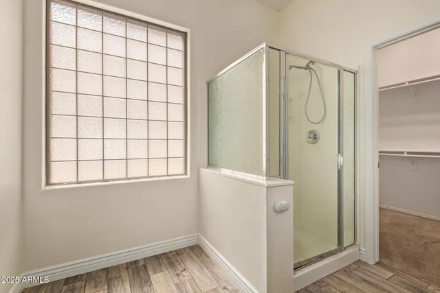 a bathroom with a shower and a window