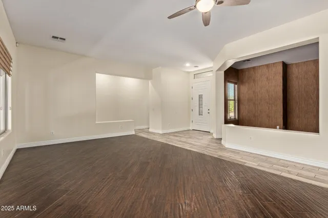 wooden floor in an empty room with a window