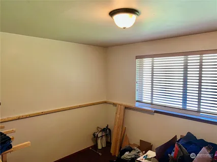 a view of a room with rack on the wall and a window