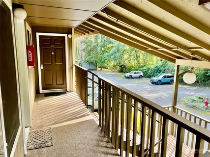 a view of balcony with wooden floor and fence
