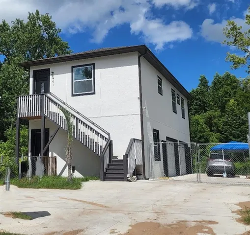 a view of house along with deck and outdoor space