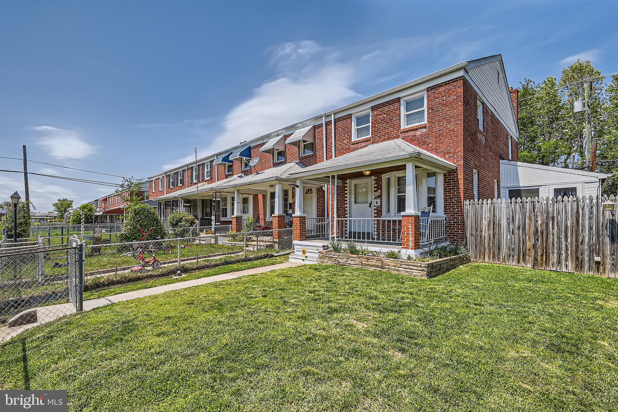 824 Middlesex Road Baltimore, MD 21221 - Photo 2 of 28 a front view of a house with a yard table and chairs