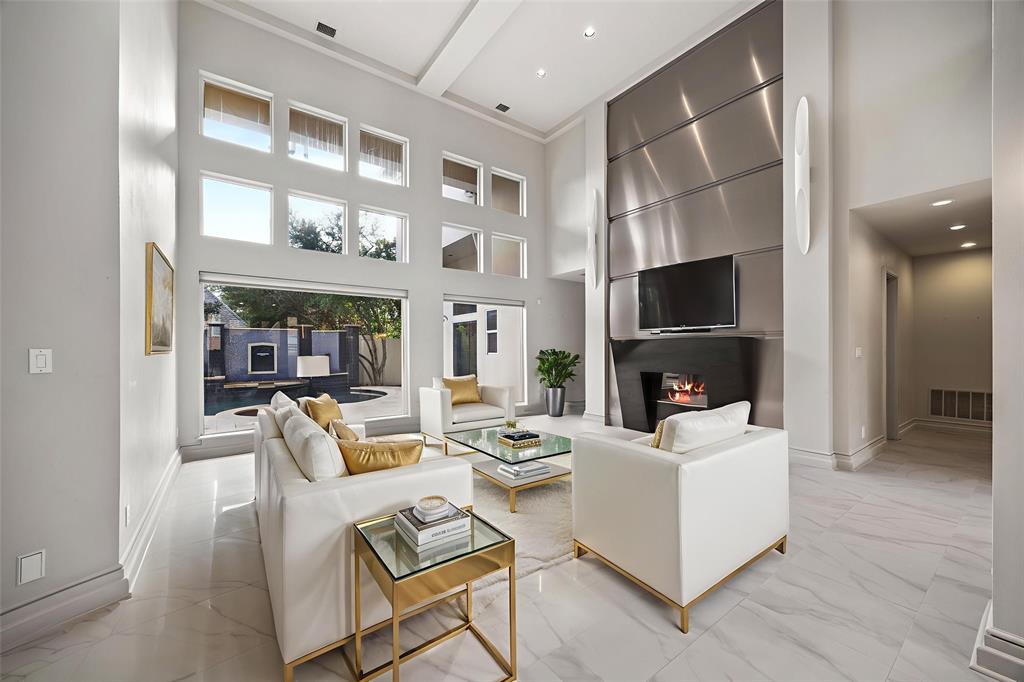 5608 Stone Cliff Court Dallas, TX 75287 - Photo 14 of 35 a living room with fireplace furniture and a flat screen tv