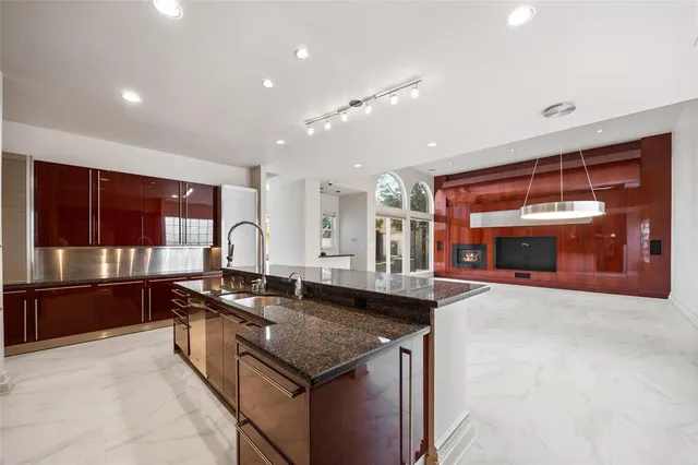 a kitchen with granite countertop a sink and a stove