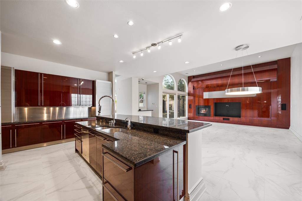 5608 Stone Cliff Court Dallas, TX 75287 - Photo 15 of 35 a kitchen with granite countertop a sink and a stove
