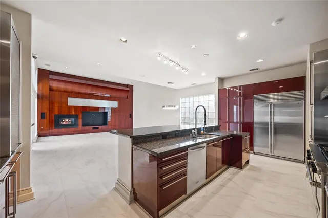 a kitchen with stainless steel appliances granite countertop a stove and a sink