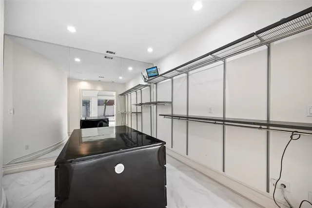 a view of kitchen with stainless steel appliances wooden floor and window
