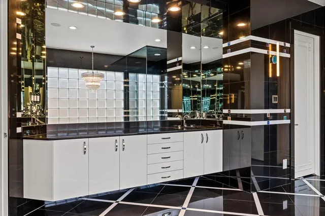 a kitchen with granite countertop a sink a stove and cabinets