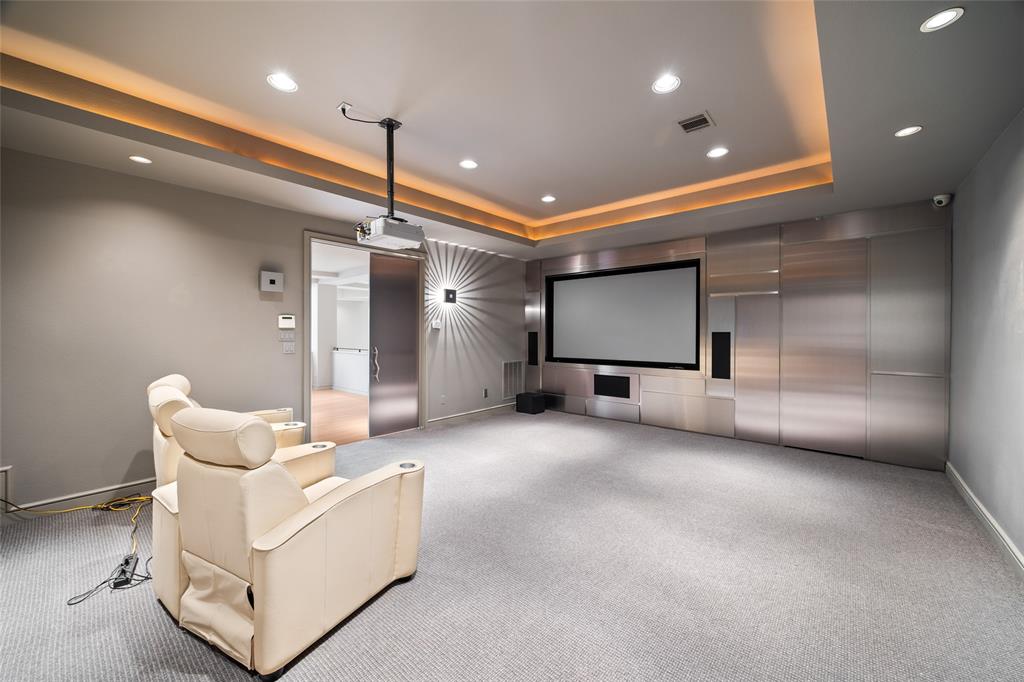 5608 Stone Cliff Court Dallas, TX 75287 - Photo 23 of 35 a living room with furniture and a chandelier