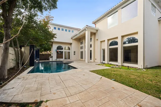 a view of a swimming pool with a back yard